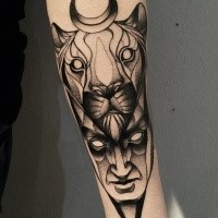 Mysterious blackwork style painted by Michele Zingales forearm tattoo of human face with lion