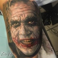 Mysterious traditionally colored Joker portrait tattoo in realism style
