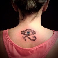 Mystical ancient Egyptian symbol the Eye of Horus tattoo on lady's upper back