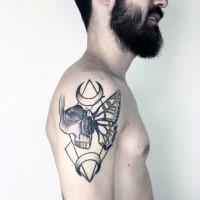 Mystical black ink shoulder tattoo of human skull stylized with butterfly wing and moons