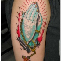 Mystical colored big praying hands with cross tattoo on shoulder