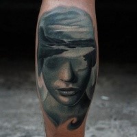 Mystical colored leg tattoo of woman face