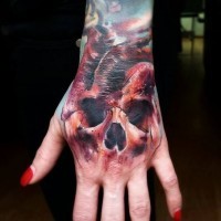 Mystical colored very detailed skull shaped on hand tattoo of heart
