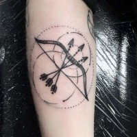 Mystical little black ink bow with circles tattoo on arm