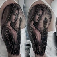 Mystical looking black ink shoulder tattoo of religious woman with strange figure