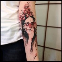 Mystical looking colored forearm tattoo of woman with flowers