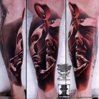 Mystical looking colored leg tattoo of amazing face with loop