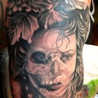 Mystical looking colored shoulder tattoo of human portrait with flowers