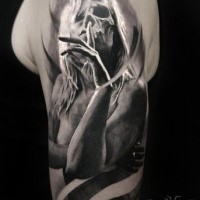 Mystical realism style shoulder tattoo of creepy woman with skull
