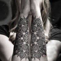 Mystical style black and white flower shaped tattoo on arms
