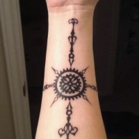 Mystical tribal style black ink sun shaped tattoo on arm