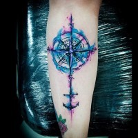 Mystical watercolor compass forearm tattoo stylized with little anchor