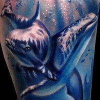 Natural looking big colored dolphins tattoo on leg