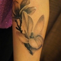 Natural looking black and white forearm tattoo of flowers