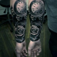 Natural looking black and white mystical clock with flower tattoo on arm
