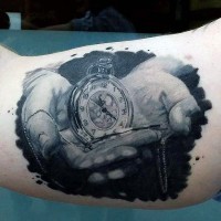 Natural looking black and white old pocket clock tattoo on hand