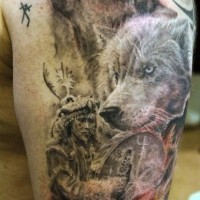 Natural looking black and white old tribal shaman on shoulder tattoo stylized with wolves