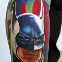 Natural looking colored and detailed Batman with symbol tattoo on leg