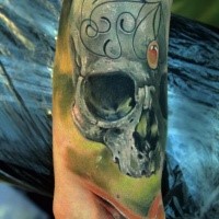 Natural looking colored arm tattoo of human skull with ornaments