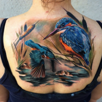 Natural looking colored back tattoo of birds