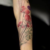 Natural looking colored forearm tattoo of wildflowers