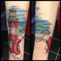 Natural looking colored lighthouse with waves tattoo on arm