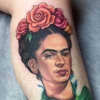 Natural looking colored Mexican woman portrait tattoo on leg