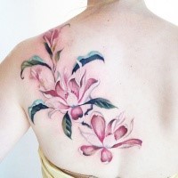 Natural looking colored scapular tattoo of beautiful flowers