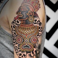 Natural looking colored shoulder tattoo of Hinduism God with skulls