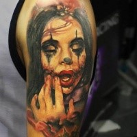 Natural looking colored shoulder tattoo of creepy woman clown