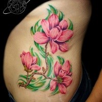 Natural looking colored side tattoo of big flower branch