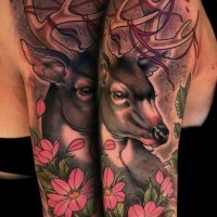 Natural looking detailed colored shoulder tattoo of deer and flowers