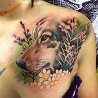 Natural looking detailed colored wolf tattoo on chest combined with beautiful flowers