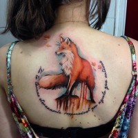Natural looking detailed colorful big fox tattoo on back combined with lettering