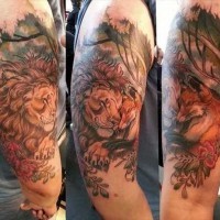 Natural looking funny sleeping lion and fox tattoo on shoulder combined with flowers and trees