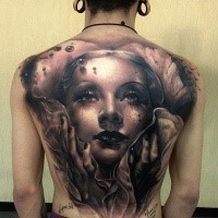Natural looking large whole back tattoo fo mystical woman portrait with signature