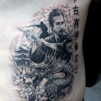 Natural looking little black ink samurai warrior tattoo on side with dragon and lettering