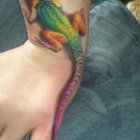 Natural looking multicolored realism style lizard tattoo on wrist