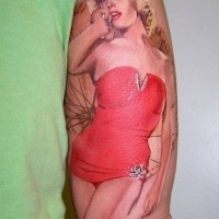 Natural looking red colored Merlin Monroe tattoo on arm