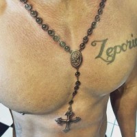 Natural looking very detailed on chest tattoo of chained cross