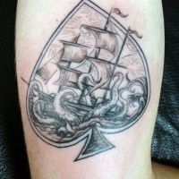Nautical themed big spades symbol with octopus and ship tattoo on arm