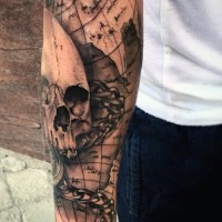 Nautical themed detailed black ink world map with skull tattoo on sleeve