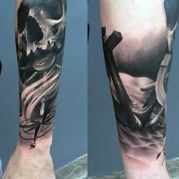 Nautical themed dramatic black ink skull tattoo on forearm with anchor and ship steering wheel