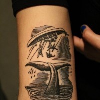 Nautical themed simple black ink wails tail with sailors tattoo on arm