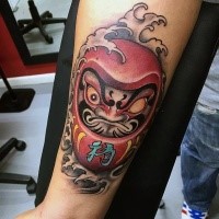 Neo japanese style colored arm tattoo of angry daruma doll
