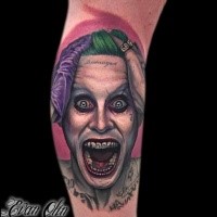 Neo traditional colored arm tattoo on creepy Joker face