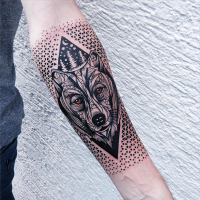 Neo traditional style colored arm tattoo of wolf head with ornaments