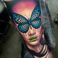 Neo traditional style colored arm tattoo of woman face with blue butterfly
