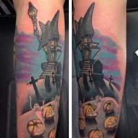 Neo traditional style colored creepy house with cemetery and pumpkins tattoo on arm