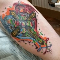 Neo traditional style colored leg tattoo of Celtic cross with dragons and lettering